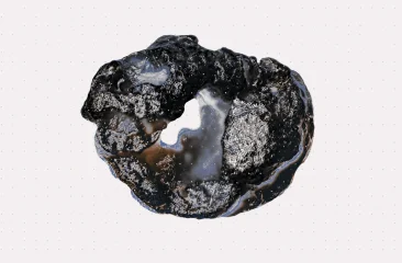 Een zwart, glasachtig object met een onregelmatige vorm.